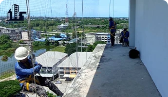 Abseiling with bird netting at a high point npnetandpaint